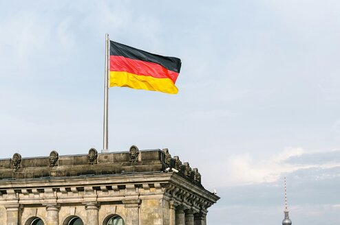 A German flag on top of a tall building